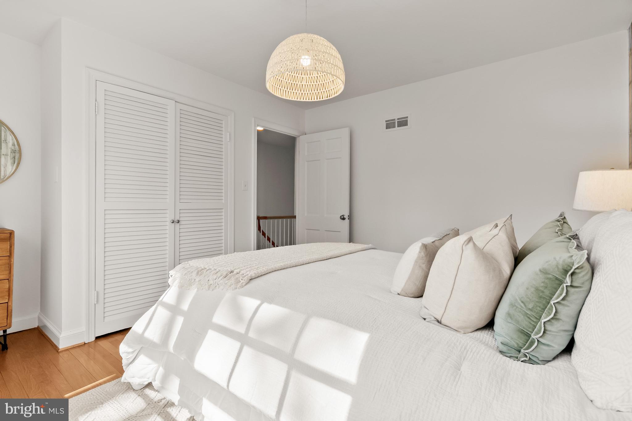 5120 Upton Street Northwest Washington, DC 20016 - Photo 31 of 53 a bedroom with a bed and a chandelier