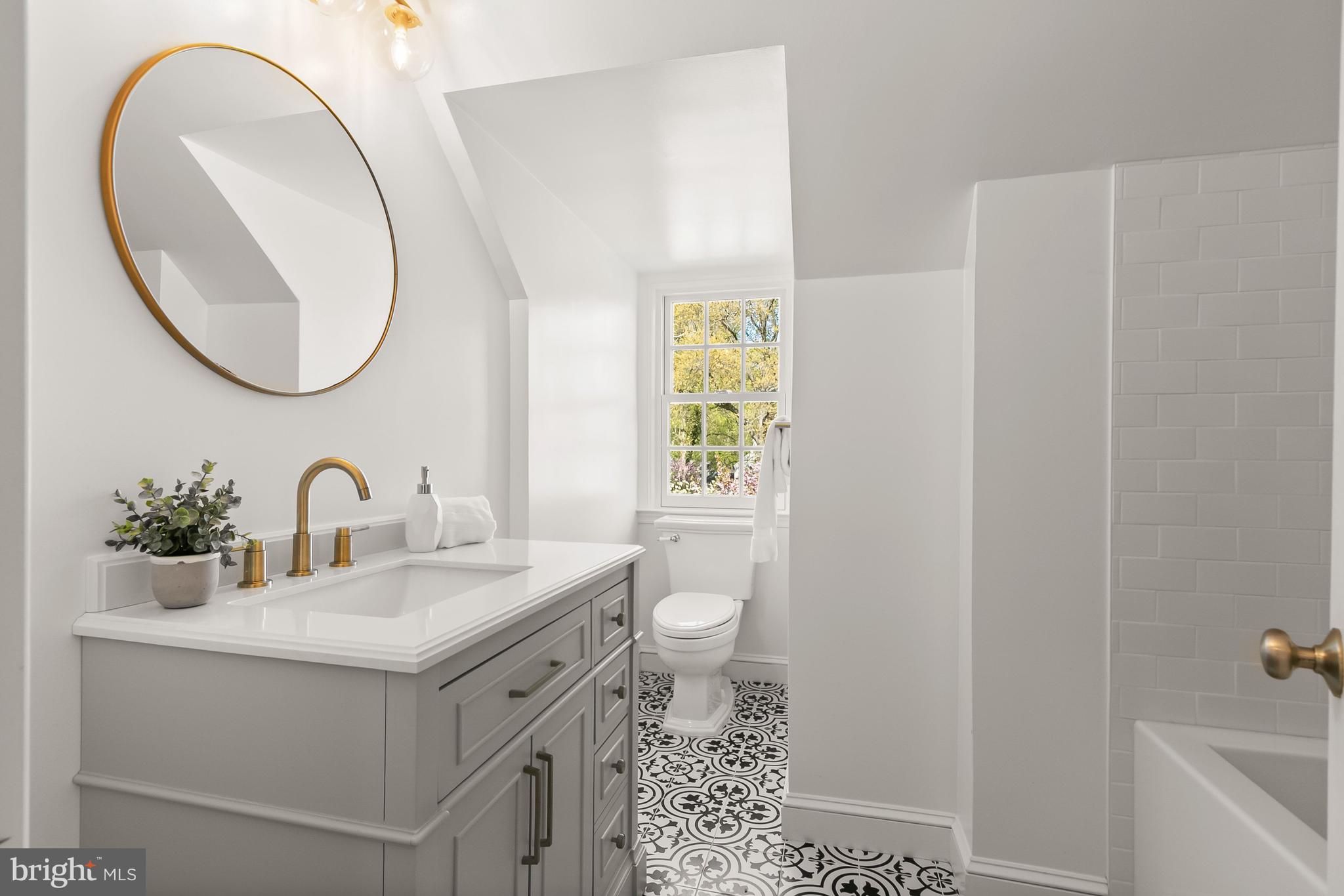 5120 Upton Street Northwest Washington, DC 20016 - Photo 32 of 53 a bathroom with a sink a toilet and a mirror