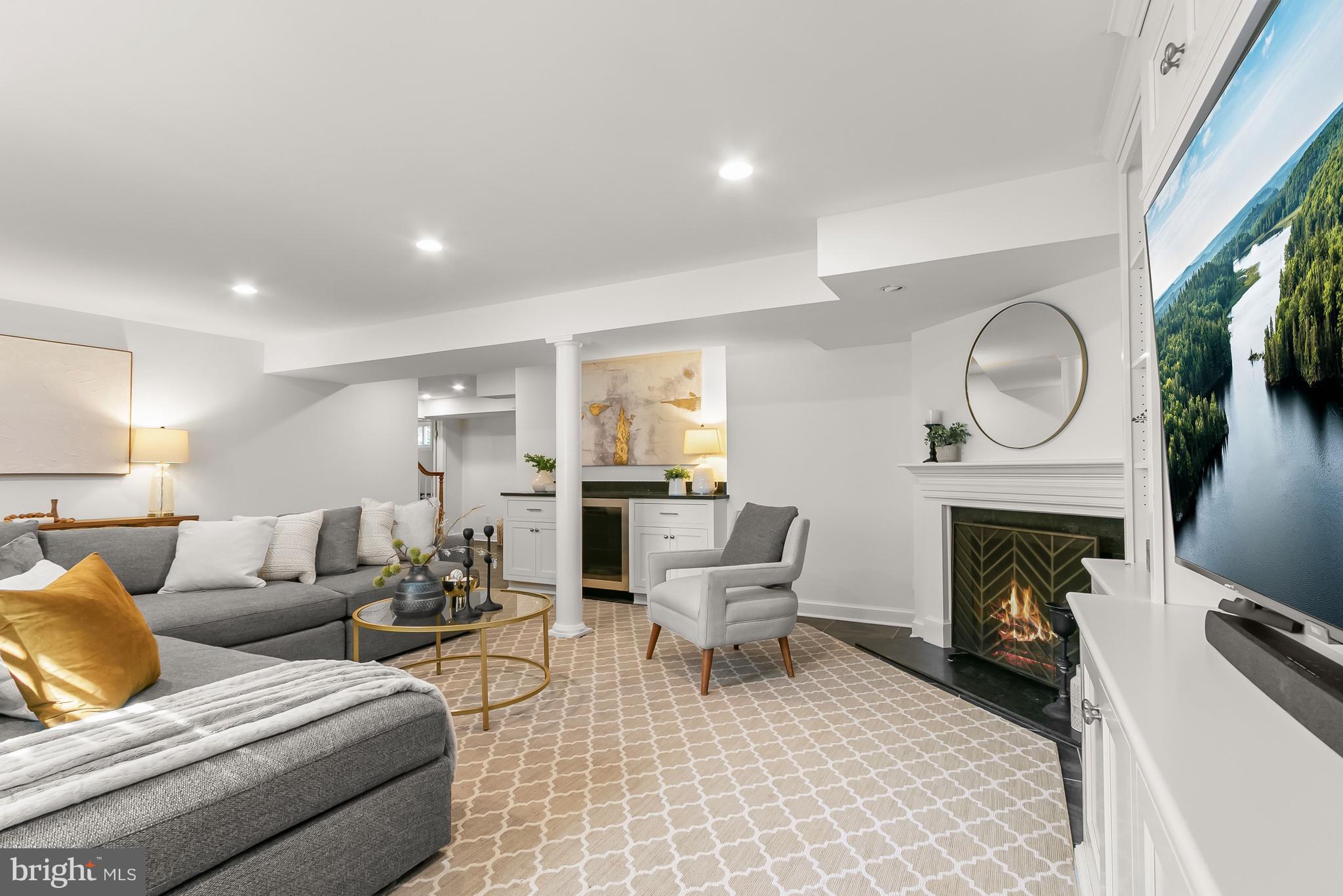 5120 Upton Street Northwest Washington, DC 20016 - Photo 40 of 53 a living room with furniture a fireplace and a flat screen tv