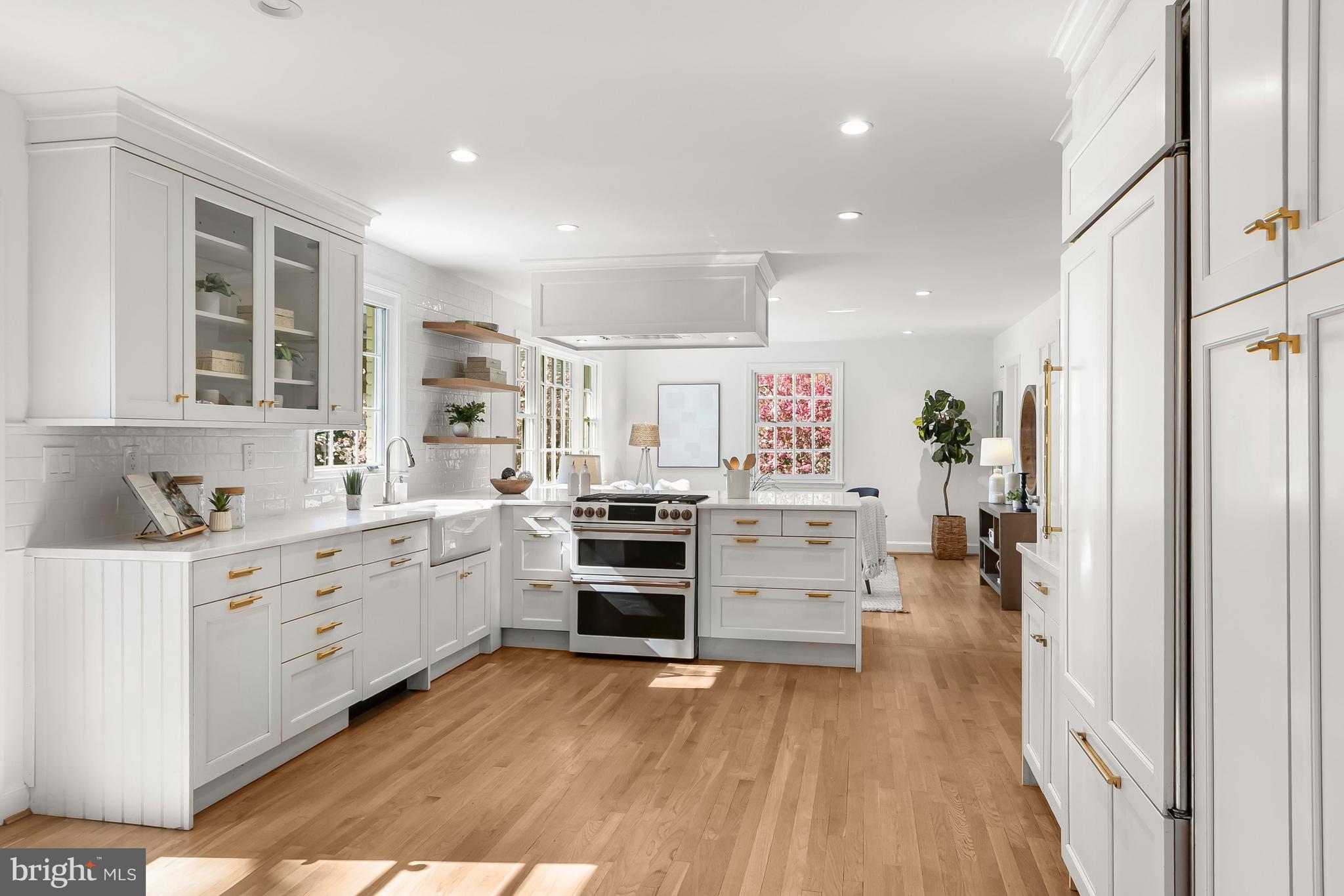 5120 Upton Street Northwest Washington, DC 20016 - Photo 9 of 53 a kitchen with white cabinets and stainless steel appliances