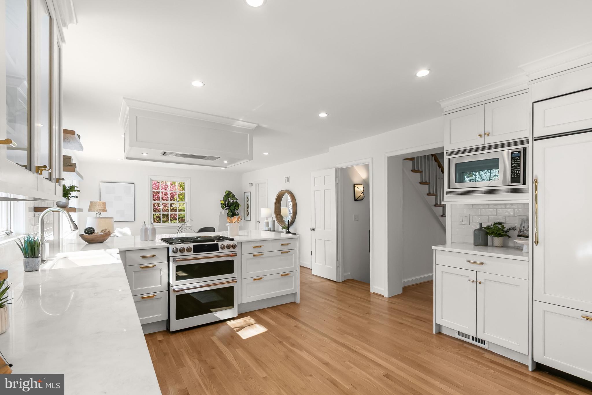 5120 Upton Street Northwest Washington, DC 20016 - Photo 10 of 53 a kitchen with stainless steel appliances kitchen island wooden cabinets and stove