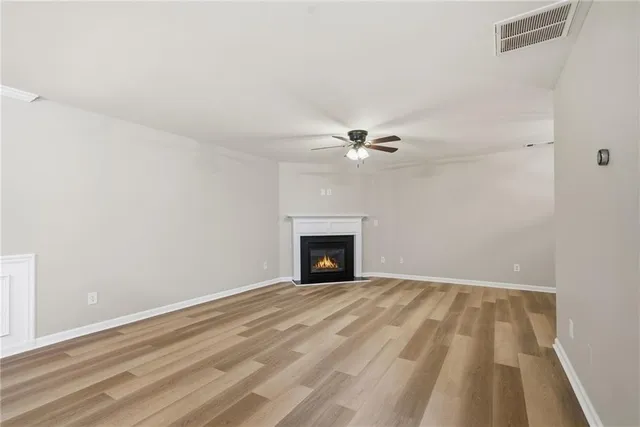 a view of empty room with ceiling fan