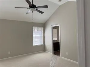 an empty room with a ceiling fan and a window