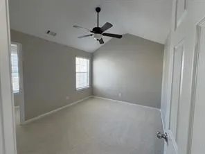 an empty room with closet and ceiling fan
