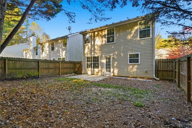a view of a deck with a slide trees and wooden fence