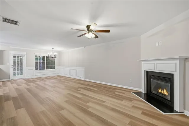 a view of empty room with fan and window