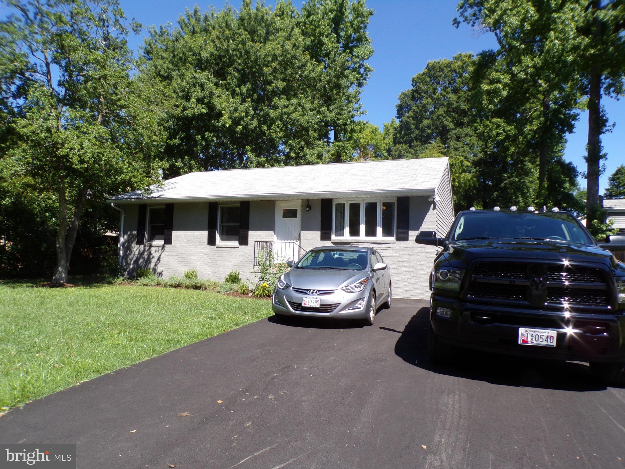 520 Brentwood Road Edgewater, MD 21037 - Photo 2 of 18 a front view of a house with a garden and trees