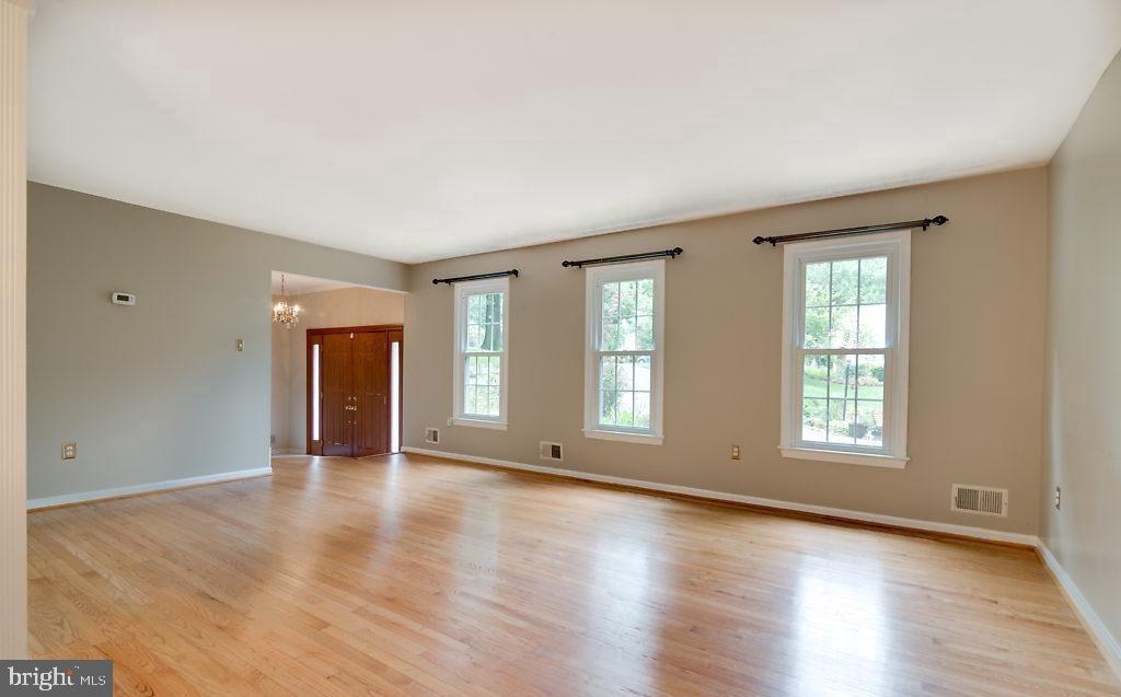 7801 Cliffside Court Springfield, VA 22153 - Photo 12 of 71 an empty room with wooden floor and windows