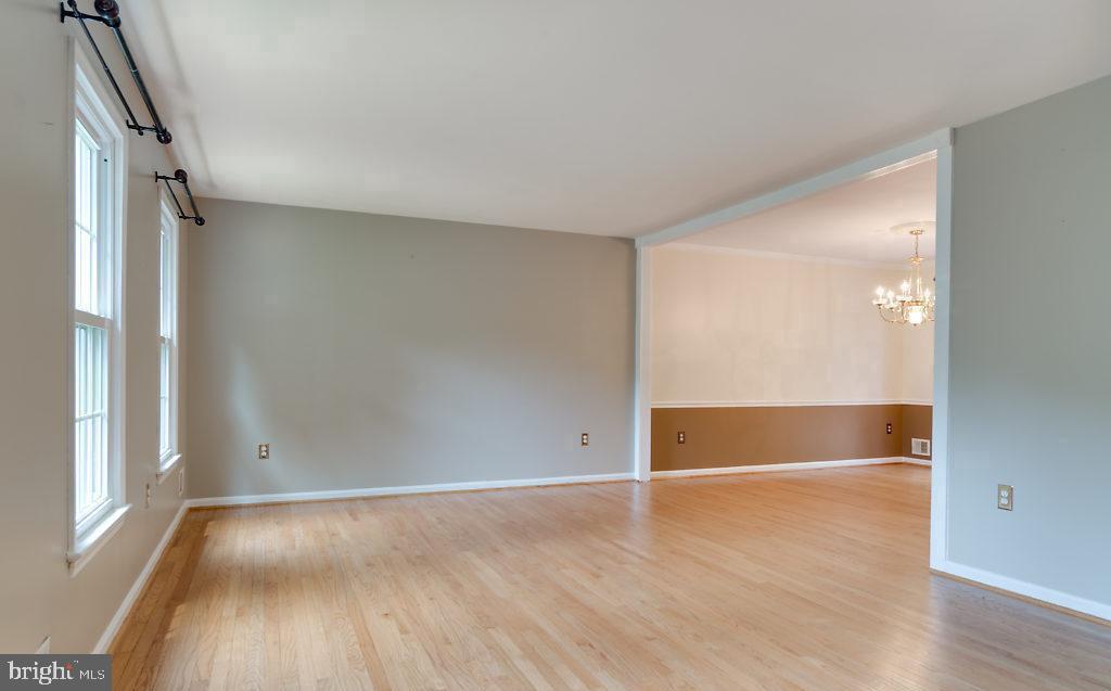 7801 Cliffside Court Springfield, VA 22153 - Photo 13 of 71 an empty room with wooden floor and windows