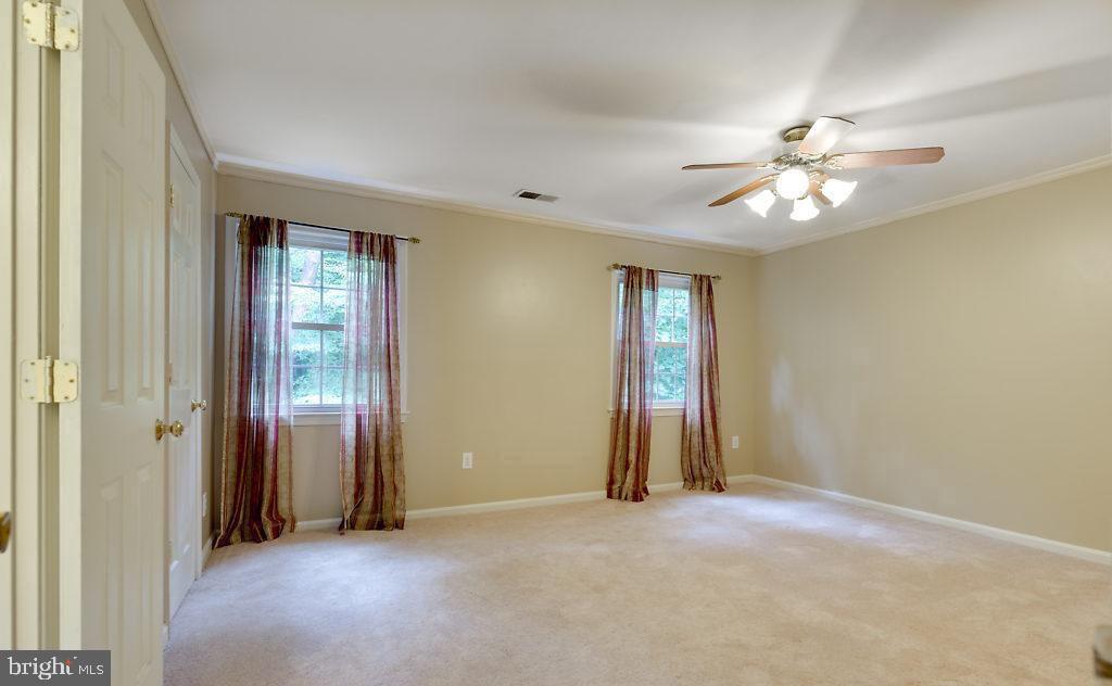 7801 Cliffside Court Springfield, VA 22153 - Photo 36 of 71 an empty room with closet and a ceiling fan