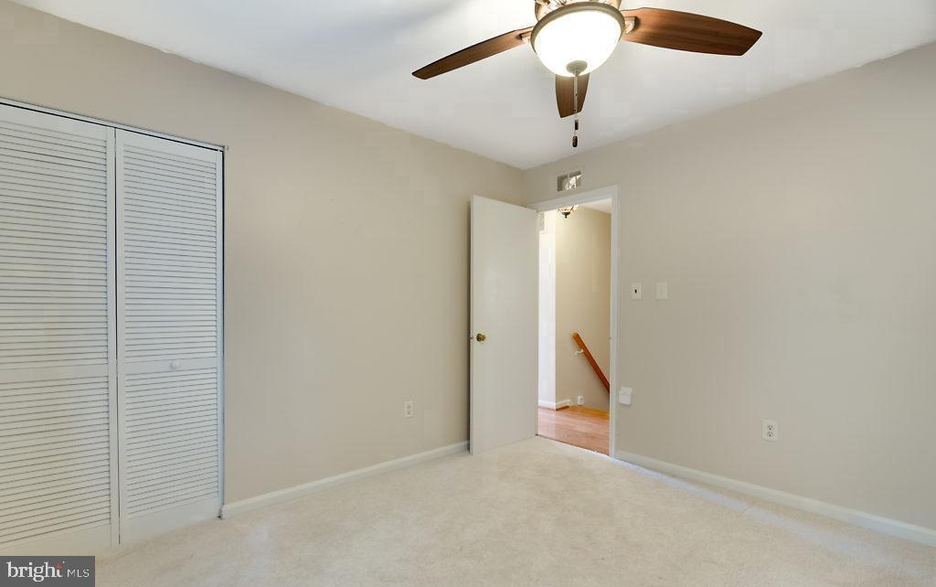 7801 Cliffside Court Springfield, VA 22153 - Photo 44 of 71 a view of an empty room with chandelier fan and windows
