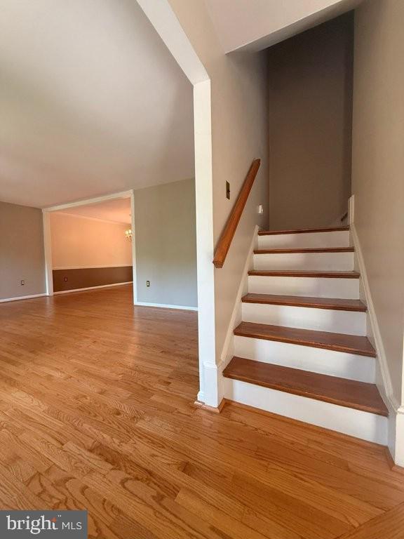 7801 Cliffside Court Springfield, VA 22153 - Photo 10 of 71 a view of an empty room with wooden floor and stairs