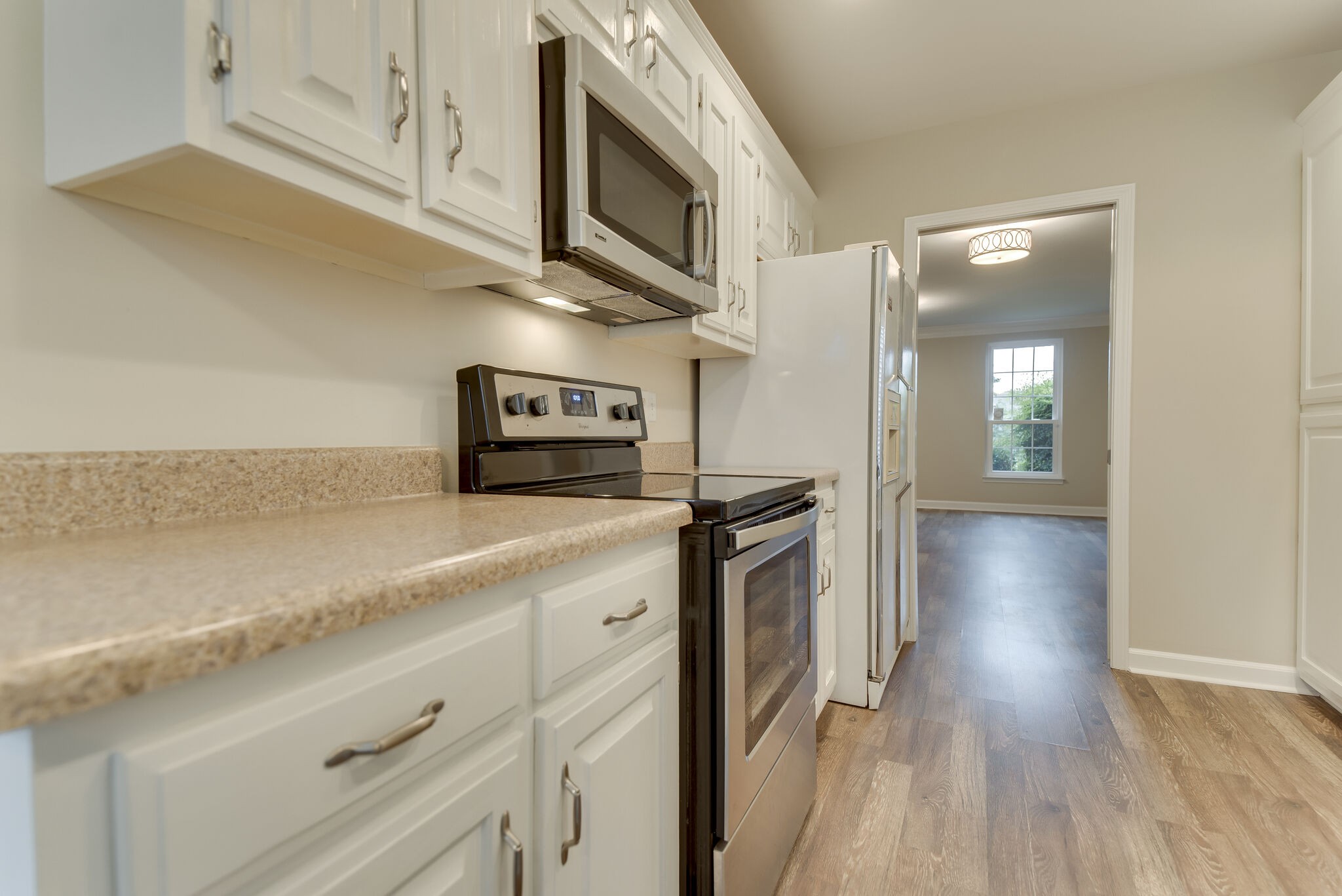 737 General George Patton Road Nashville, TN 37221 - Photo 23 of 36 a kitchen with stainless steel appliances granite countertop a refrigerator a stove and a wooden floors