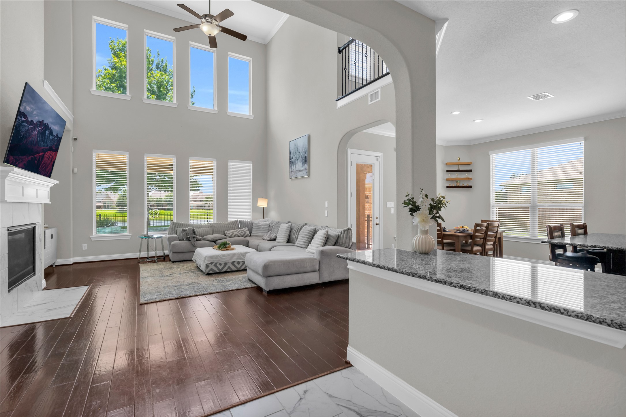 9842 Kirkstone Terrace Drive Spring, TX 77379 - Photo 10 of 34 spacious living area with high ceilings and an open layout seamlessly connects to a large kitchen, perfect for entertaining.