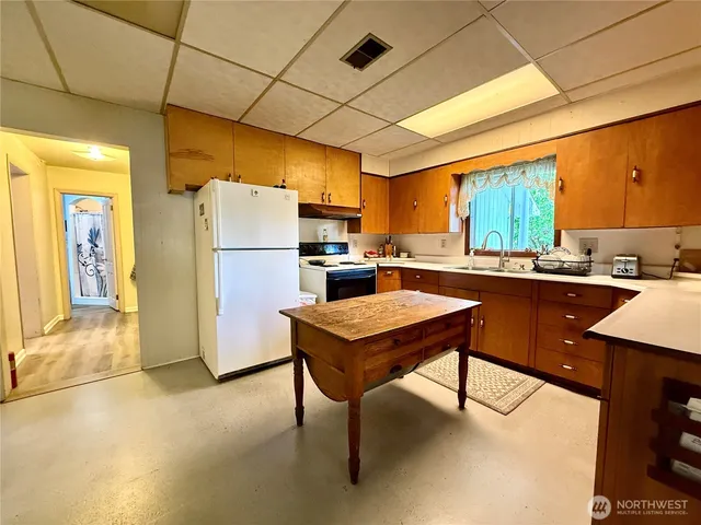 a kitchen with a sink appliances and cabinets