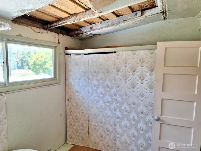 a kitchen with stainless steel appliances granite countertop a refrigerator a sink dishwasher a stove and a dining table with wooden cabinet