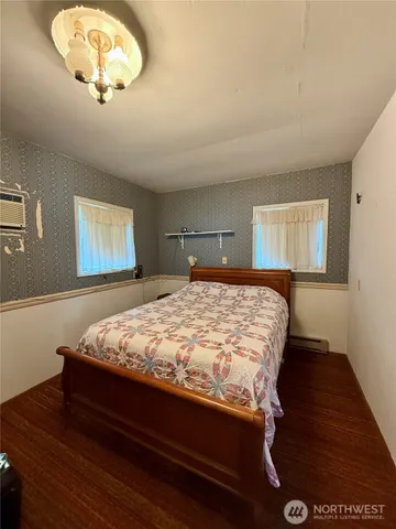 a bedroom with a bed and a lamp on table