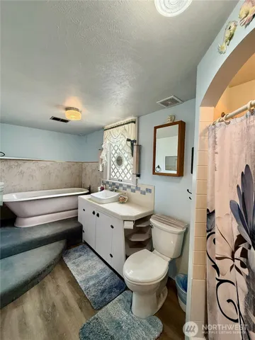 a bathroom with a toilet sink and mirror