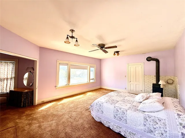 a bedroom with a large bed and a window