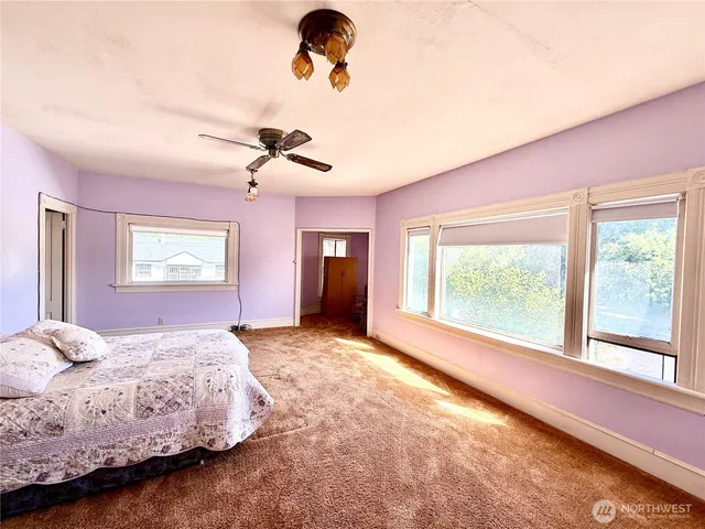 a spacious bedroom with a bed and a window