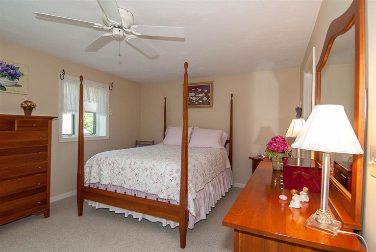 481 Buck Island Road, Unit 15D West Yarmouth, MA 02673 - Photo 14 of 21 a bedroom with a bed and a chandelier
