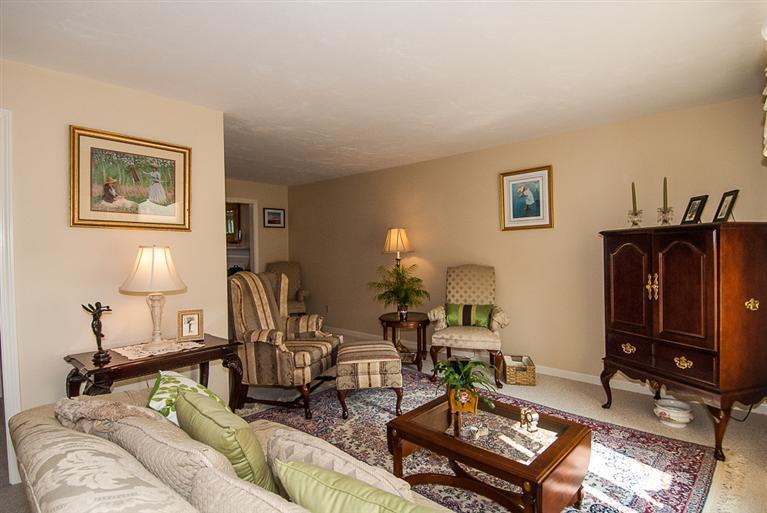 481 Buck Island Road, Unit 15D West Yarmouth, MA 02673 - Photo 9 of 21 a living room with furniture a flat screen tv and a table