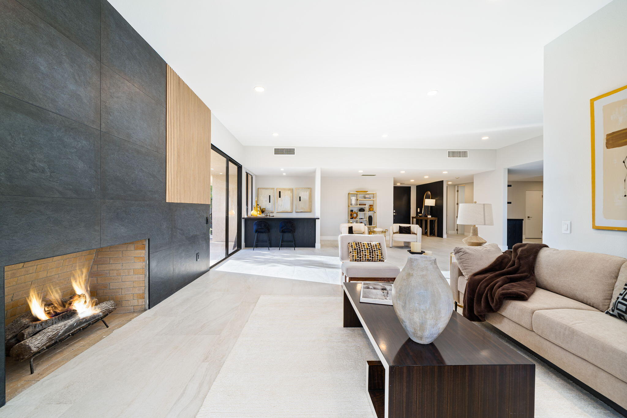 a living room with furniture a fireplace and a flat screen tv