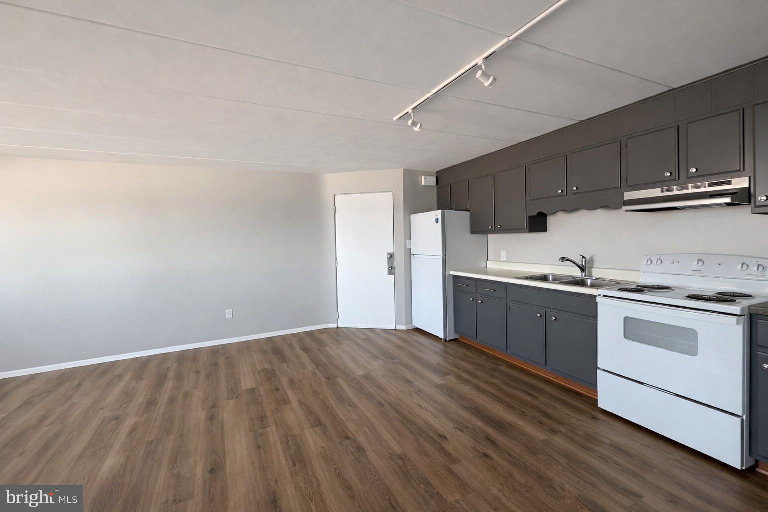 403 North Newberry Street, Unit 303 York, PA 17401 - Photo 2 of 11 a kitchen with a stove cabinets and wooden floor