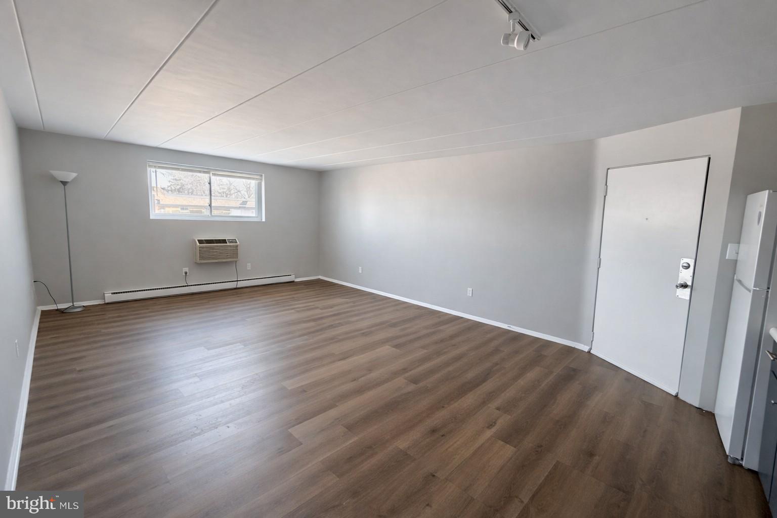 403 North Newberry Street, Unit 303 York, PA 17401 - Photo 4 of 11 an empty room with wooden floor and windows