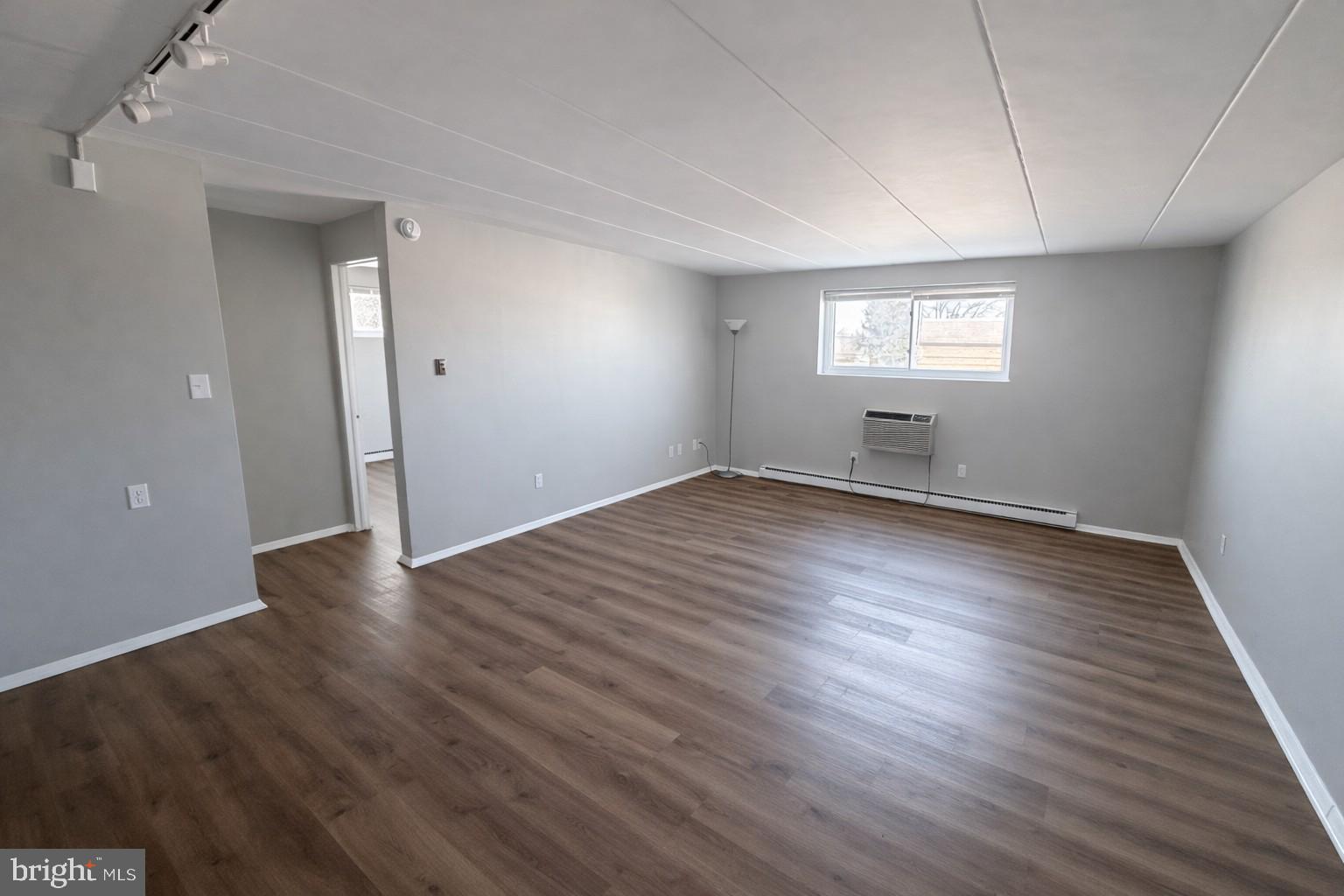 403 North Newberry Street, Unit 303 York, PA 17401 - Photo 5 of 11 an empty room with wooden floor and windows