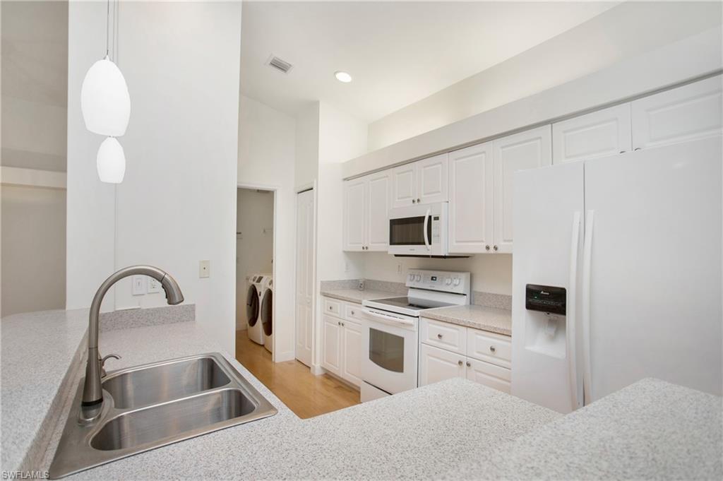 20951 Rivers Ford Estero, FL 33928 - Photo 15 of 49 a kitchen with a sink white cabinets and stainless steel appliances