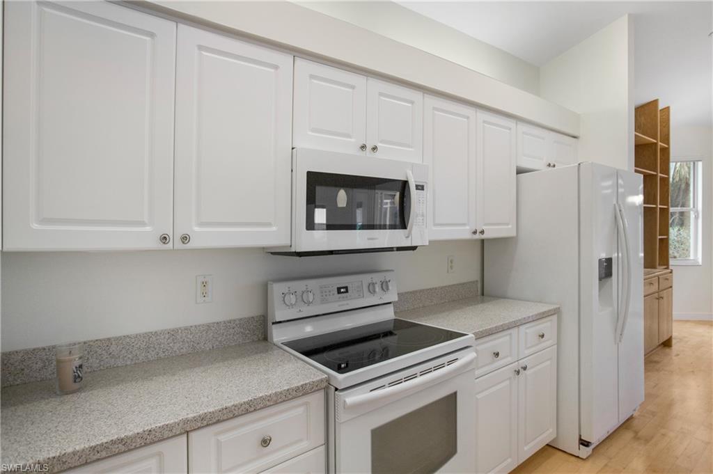 20951 Rivers Ford Estero, FL 33928 - Photo 17 of 49 a kitchen with white cabinets and white appliances