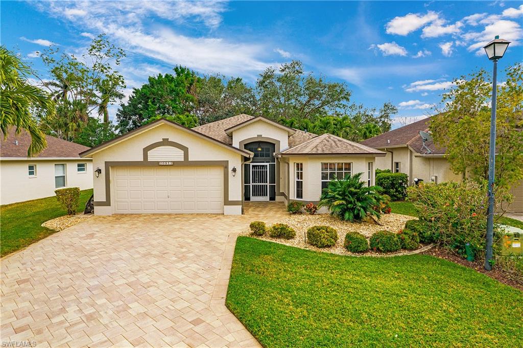 20951 Rivers Ford Estero, FL 33928 - Photo 2 of 49 a front view of a house with garden