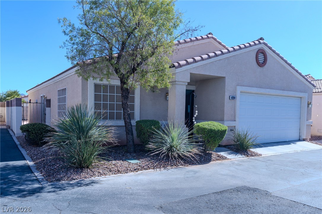 4994 Mascaro Drive Las Vegas, NV 89122 - Photo 29 of 30 A desert-friendly landscape accents the stucco facade and attached garage of this single-story residence.