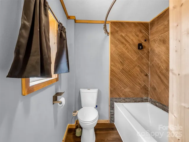 a bathroom with a toilet and a shower