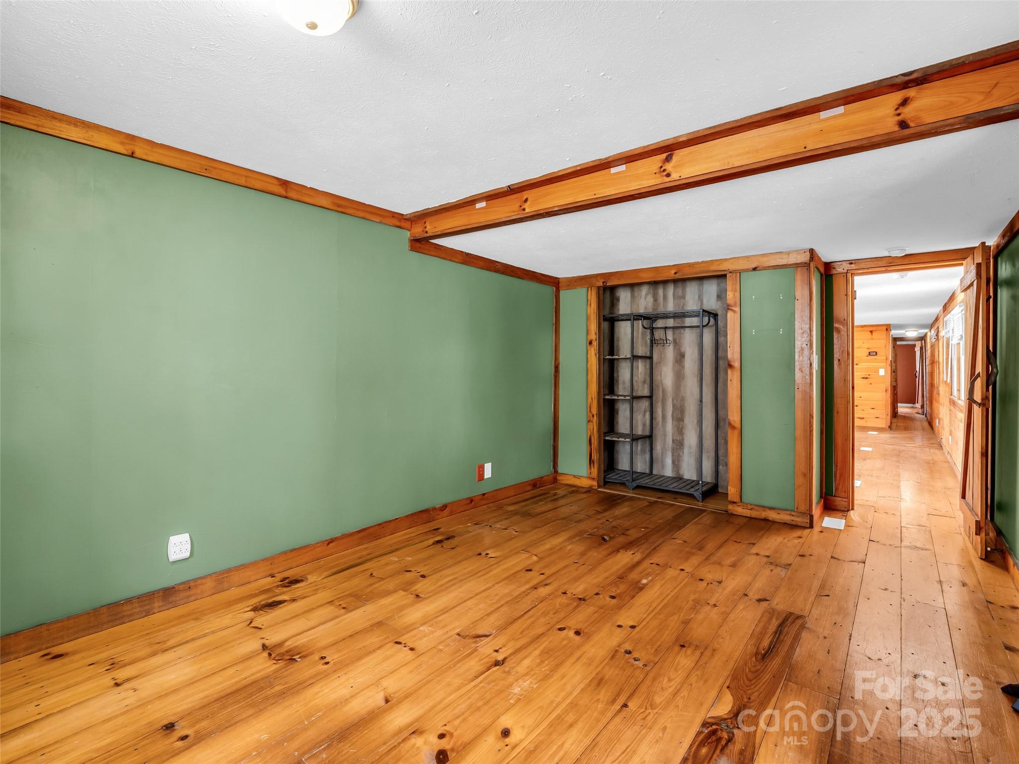 3620 Howard Gap Road Saluda, NC 28773 - Photo 24 of 35 a view of a big room with wooden floor and windows