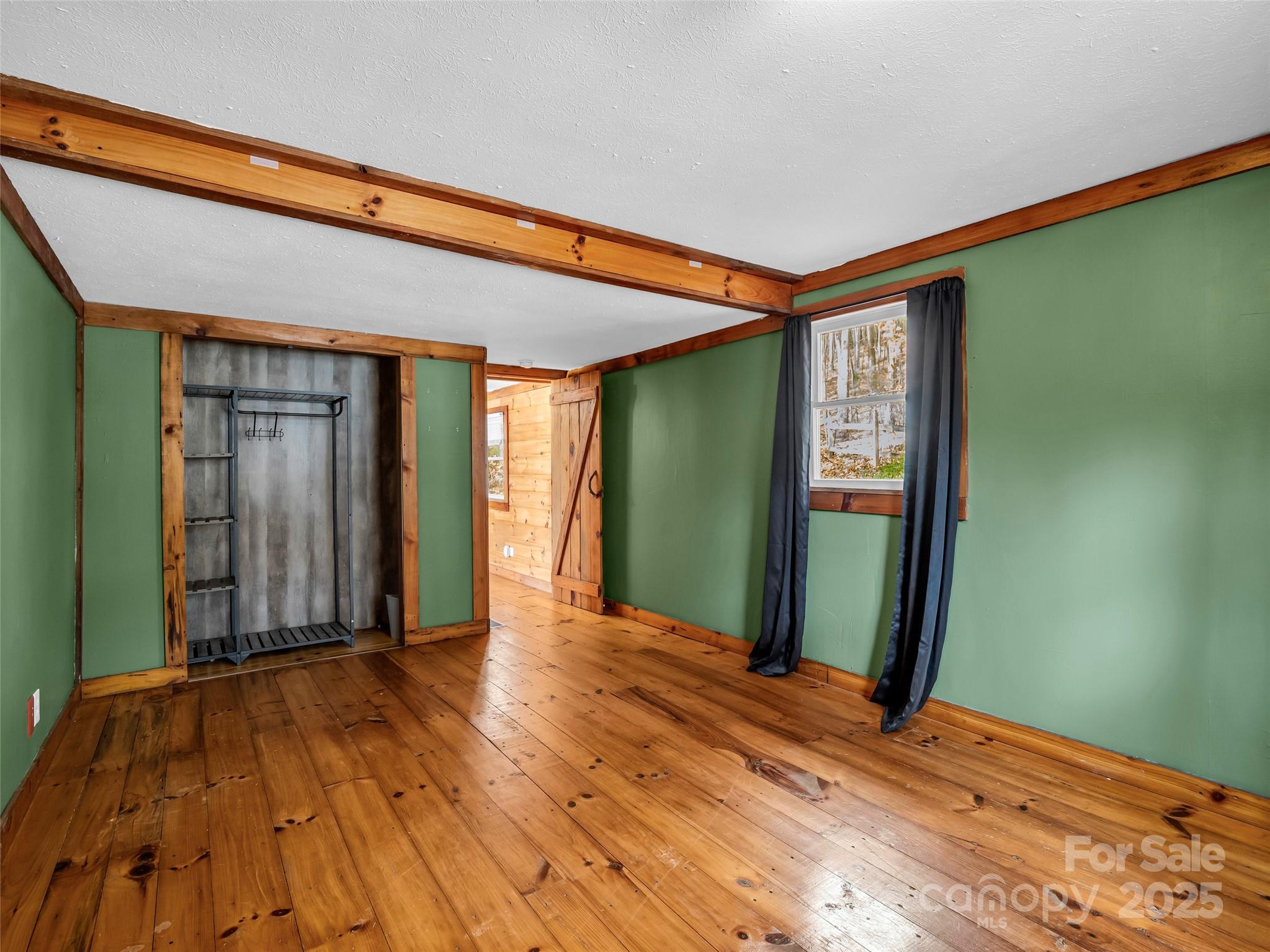 3620 Howard Gap Road Saluda, NC 28773 - Photo 25 of 35 a view of a room with wooden floor and windows