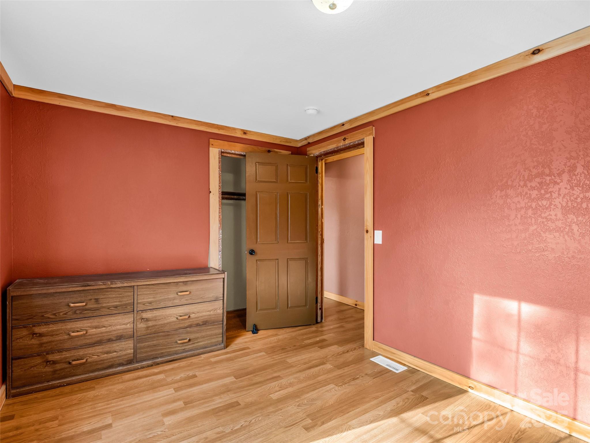 3620 Howard Gap Road Saluda, NC 28773 - Photo 28 of 35 an empty room with wooden floor and cabinet