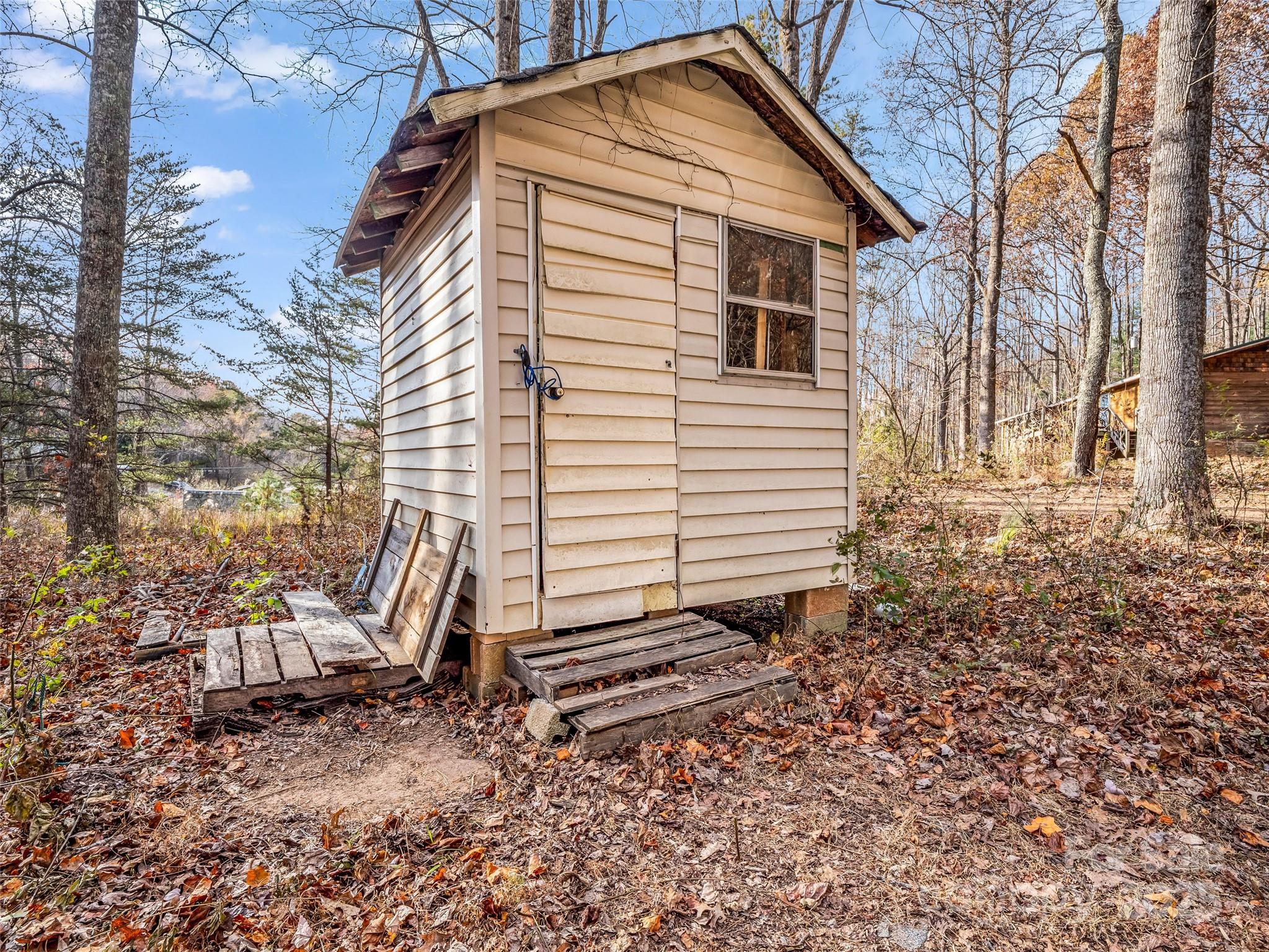 3620 Howard Gap Road Saluda, NC 28773 - Photo 35 of 35 a view of a small house with a yard and furniture
