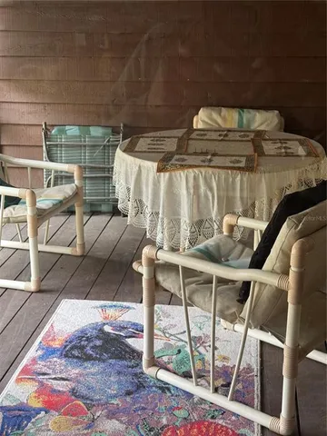 a roof deck with table and chairs