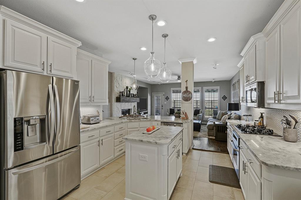 a kitchen that has a lot of stainless steel appliances