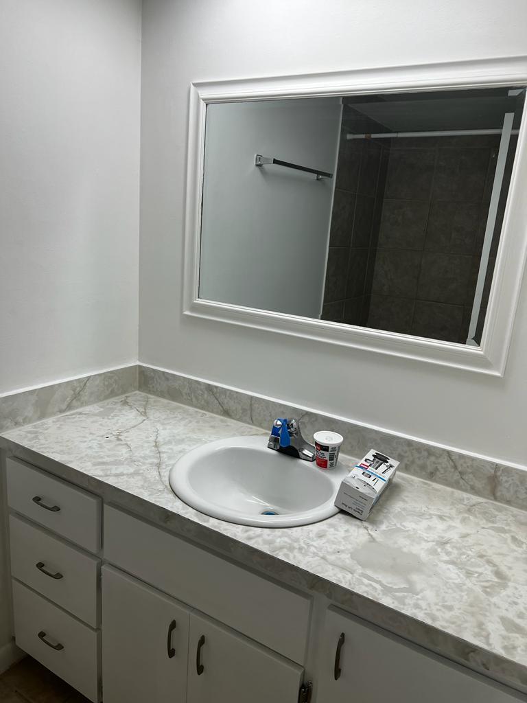 4429 Melvin Road, Unit A Lake Worth Beach, FL 33461 - Photo 13 of 20 a bathroom with a sink and a mirror