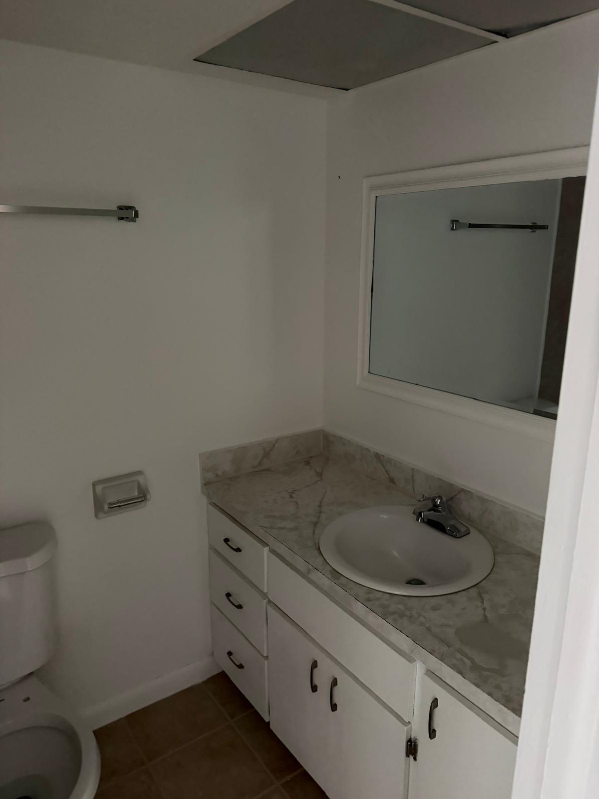 4429 Melvin Road, Unit A Lake Worth Beach, FL 33461 - Photo 14 of 20 a bathroom with a granite countertop sink and a toilet