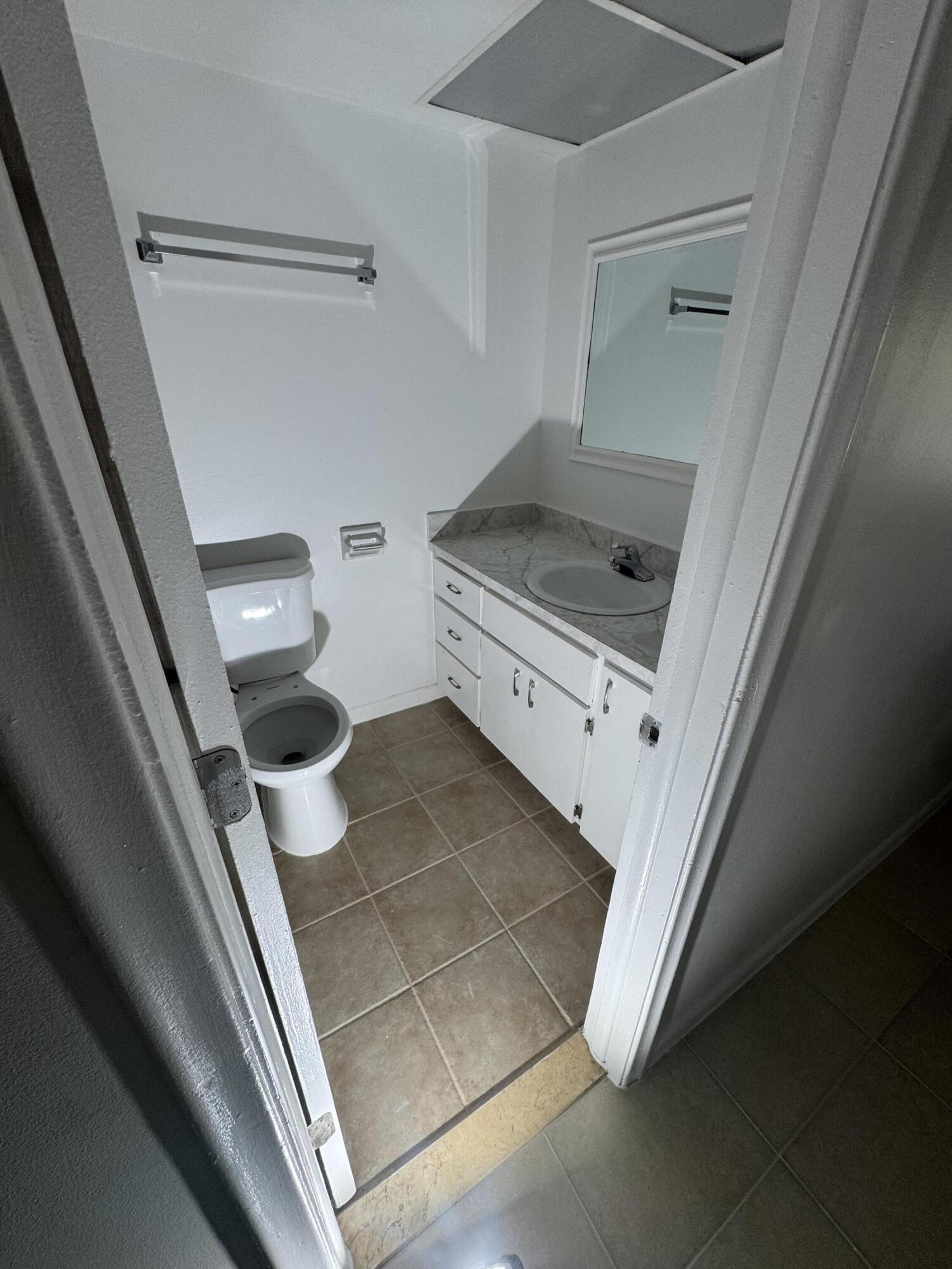 4429 Melvin Road, Unit A Lake Worth Beach, FL 33461 - Photo 17 of 20 a bathroom with a sink and toilet