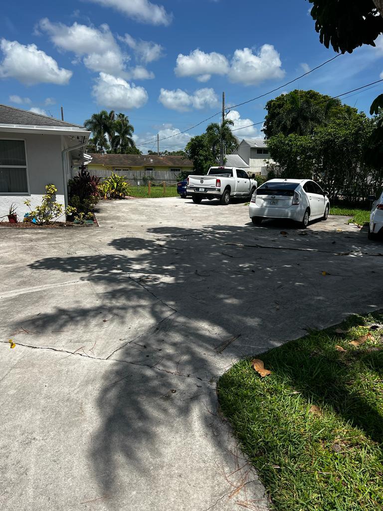 4429 Melvin Road, Unit A Lake Worth Beach, FL 33461 - Photo 2 of 20 a car parked on the side of the road