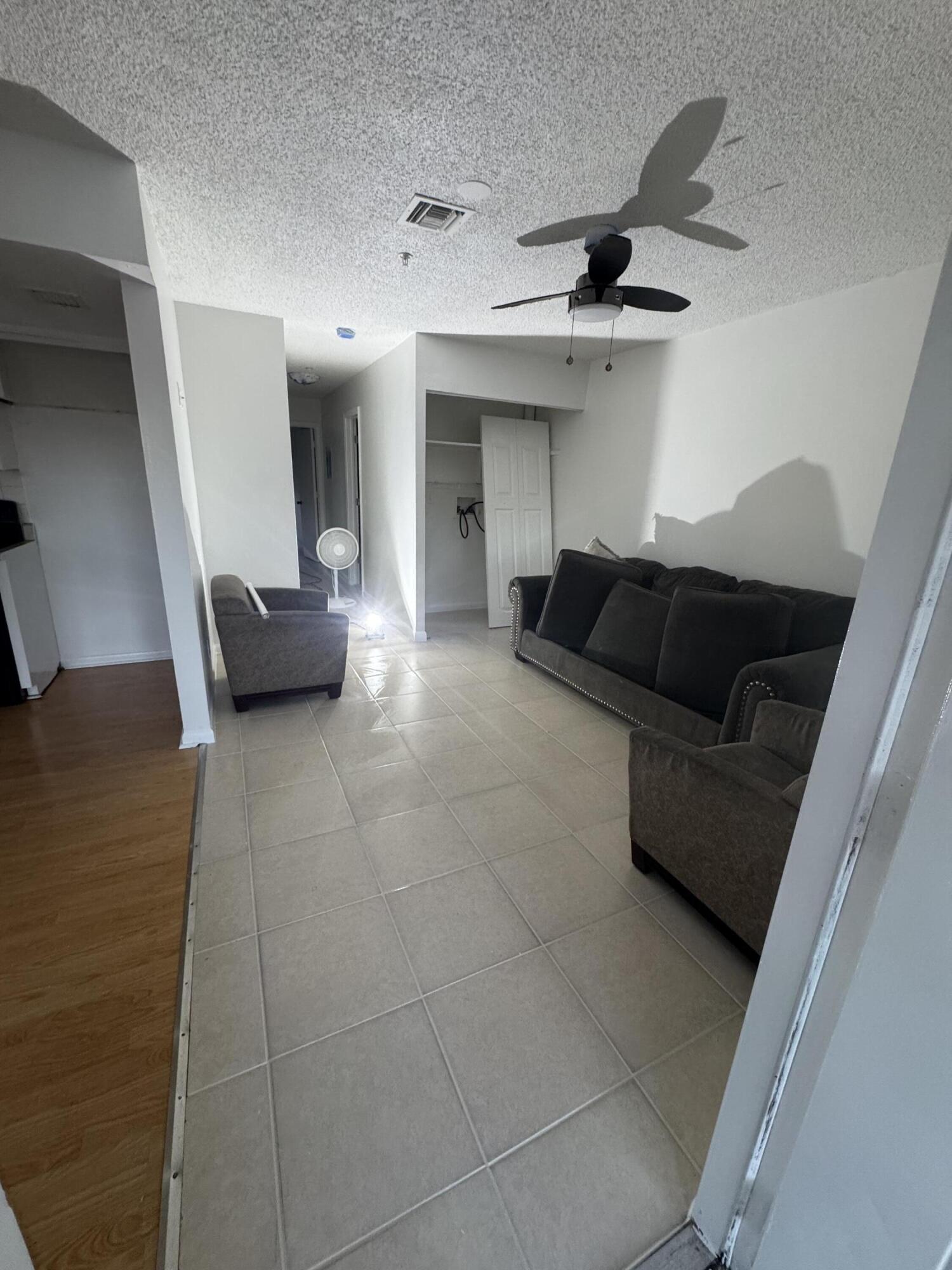 4429 Melvin Road, Unit A Lake Worth Beach, FL 33461 - Photo 3 of 20 a living room with furniture and a ceiling fan