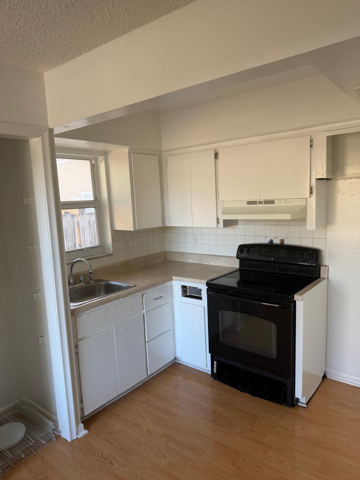4429 Melvin Road, Unit A Lake Worth Beach, FL 33461 - Photo 6 of 20 a kitchen with granite countertop a stove and a sink