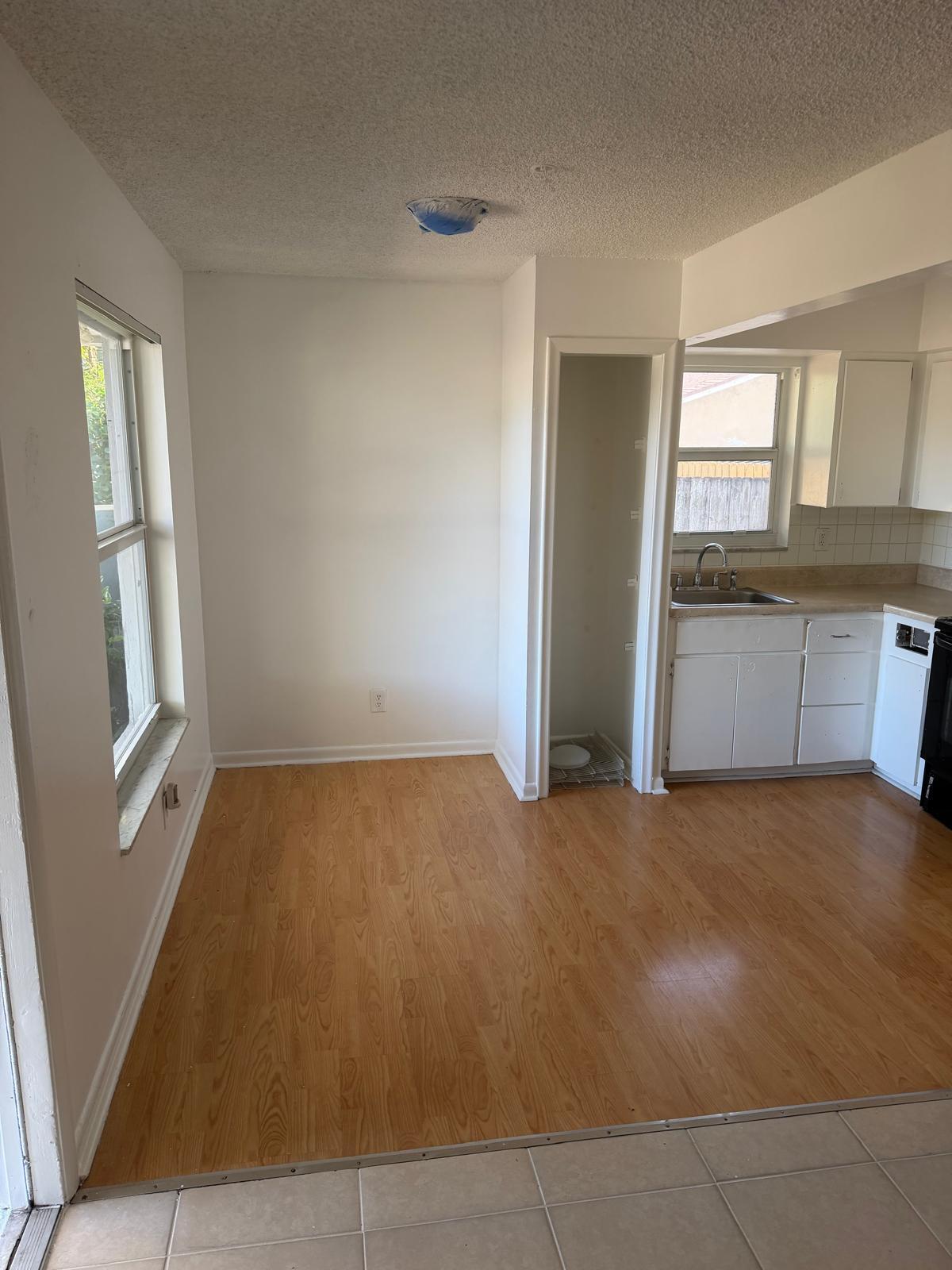 4429 Melvin Road, Unit A Lake Worth Beach, FL 33461 - Photo 8 of 20 a view of an empty room with window and cabinet area