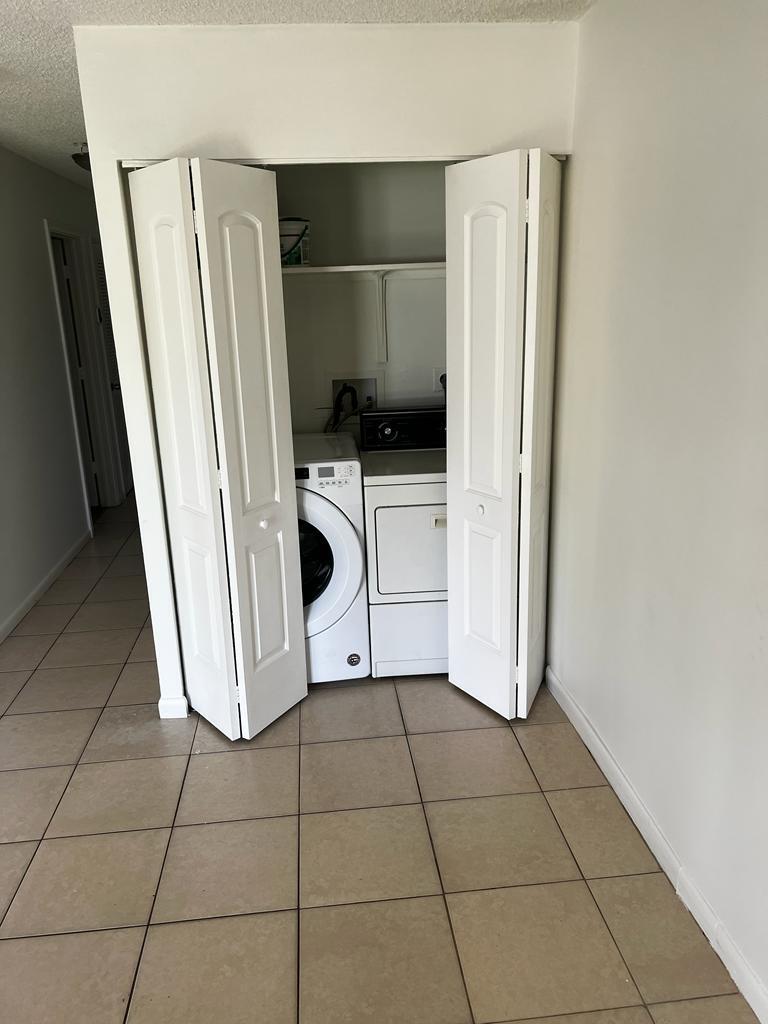 4429 Melvin Road, Unit A Lake Worth Beach, FL 33461 - Photo 9 of 20 a kitchen with a refrigerator and white cabinets