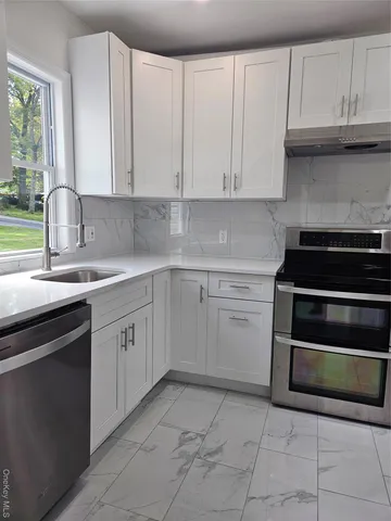 a kitchen with cabinets appliances and a sink